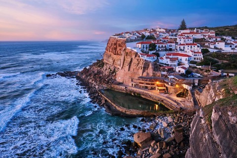 Scenic view of the seaside Azenhas do Mar fishing village on cliff on Atlantic ocean coast,