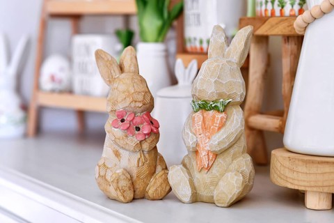 Pair of cute rustic Easter bunny decoration with flowers and carrots