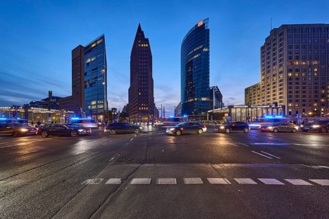 Police operation with blue light, vehicles with motion blur, skyscrapers Forum Tower, Kollhoff