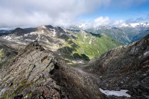 Steep rocky ridge, at the summit of the Lasörling, view of the mountain panorama of the Venediger