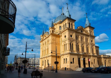 Imposing church with neoclassical façade and towers, located in the city centre with pedestrian