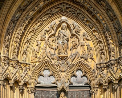 Stonework carvings God in heaven above doorway, The Judgement Porch, Lincoln Cathedral, Lincoln,