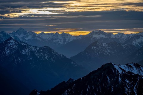 Mountain panorama with snow at sunset, in autumn, view from Kramerspitz, Bavarian Prealps, Bavaria,