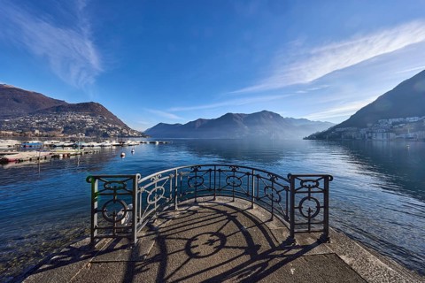 Lake, lakeside promenade, railing, mountains, haze, shadow, backlight, Lake Lugano, Lugano,