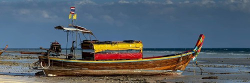 Longtail boat on the beach, at low tide, Koh Ngai Island, Andaman Sea, Satun Province, Southern