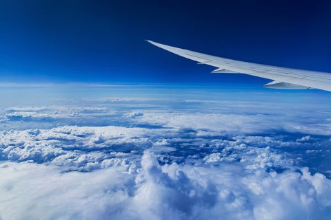 View from the aircraft window during a flight over India with the airline Etihad. Blue sky and