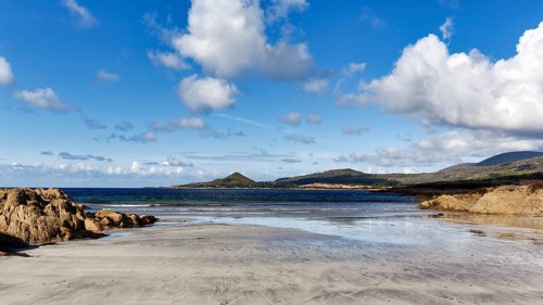 Sandy beach beach, rocky coast in bay at low tide, White Strand, Castlecove, panoramic road Ring of