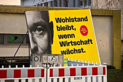 Large FDP election poster with Christian Lindner for the 2025 Bundestag election behind a barrier,