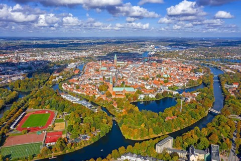 Aerial view over the river Trave and church towers in the old town of the Hanseatic City of Lübeck