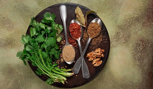 Georgian spices in spoons, on ketsi, top view, no people