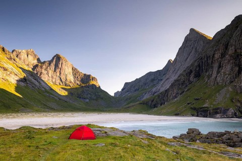 Red tent on Horseid beach, sandy beach with mountains, Lofoten, Norway, Europe