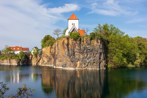 Mountain church on the Kirchberg, surrounded by the Kirchbruch quarry lake, striking view of