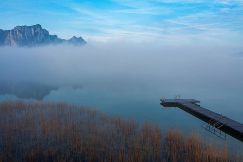 Drone shot, reed belt with bathing jetty in the morning fog, Mondsee, Salzkammergut, Upper Austria,