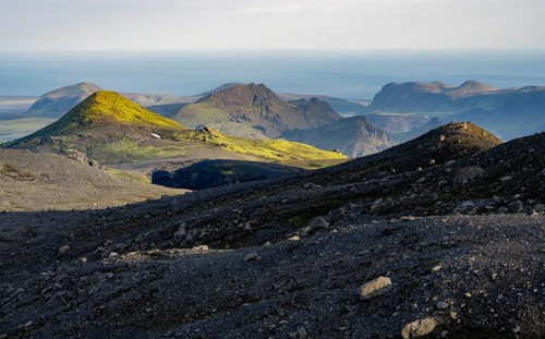 Volcanic mountain landscape overgrown with moss, atmospheric mountain landscape in the evening