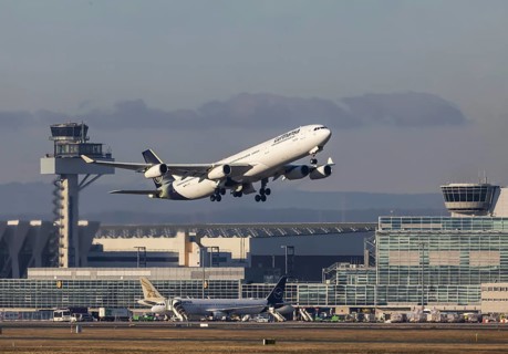 Aircraft takes off in front of the terminal and tower at Fraport Airport. Aircraft registration