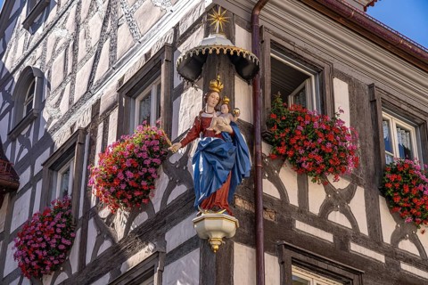 Madonna with child and floral decoration on a half-timbered house in Forchheim, Upper Franconia,