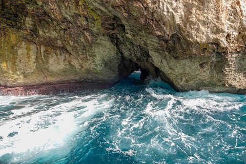 Rugged coastal landscape with rocky cave and wild sea waves, Maria di Leuca, Apulia, Italy, Europe