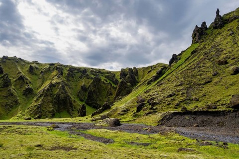 Stream bed in a green moss-covered gorge, enchanted volcanic landscape, Pakgil, Iceland, Europe
