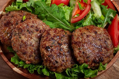 Fried cutlets, mixed minced meat, with vegetable salad, homemade, top view, no people