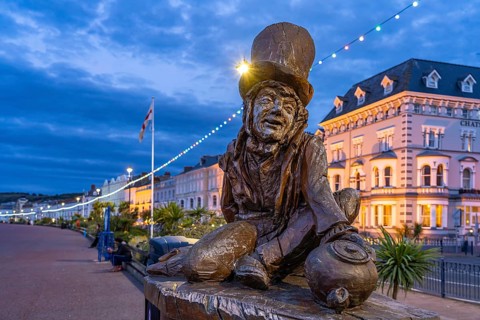 Sculpture of the Mad Hatter or The Mad Hatter from Alice in Wonderland on the promenade of the