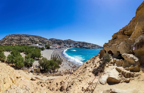 View from the rock caves to the beach of Matala, south coast, Crete, Greece, Europe