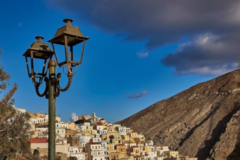 Old village in the mountains under a blue sky with streetlights in the foreground, Colourful