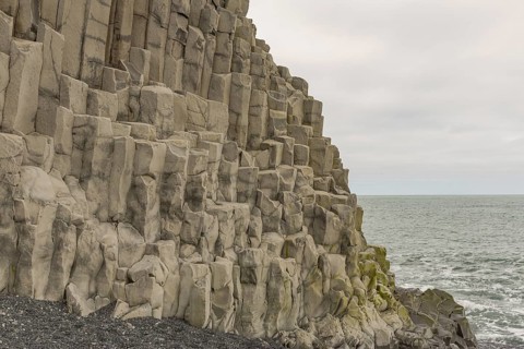 Reynisfjara Beach with Basalt rocks (Stuolabrrg) and the rock needles (Haidrangur), close to Vik i