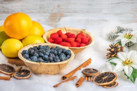 Healthy fruit and berries, white background, Christmassy decoration