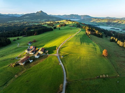 Mountain range near village Wertach, view to mt. Gruenten, sunrise, fog in valley, autumn colors,