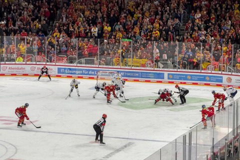 Players and referee in line-up for face-off during ice hockey in multifunctional hall, in the