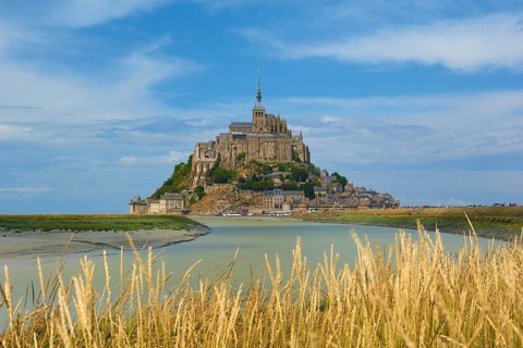 Picturesque view of Mont Saint-Michel on an island with medieval architecture, summer, Le