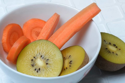 Sliced carrot and kiwi slices in peel, kiwi fruit and carrot