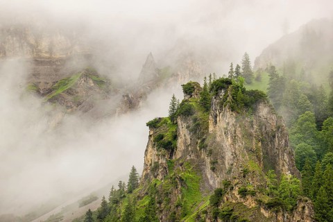Wisps of mist cover the Karwendel mountains in the Großer Ahornboden nature reserve, Eng Valley,