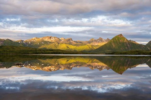 Mountains reflected in the sea, near Laukvik, Austvågøya, Lofoten, Norway, Europe