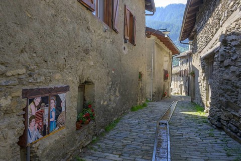 Pictures on the house walls characterise the narrow streets with old houses in the village,