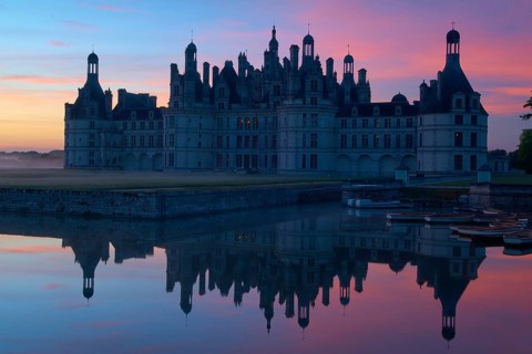 Chambord Castle with moat at sunrise, Chambord, Department Loir-et-Cher, Centre region, France,