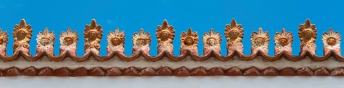 Close-up of a decorative roof ornament with ornate patterns under a blue sky, Poros, Poros Island,