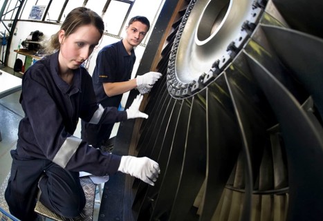 Trainees in the training workshop of Trainico, training as aircraft mechanics on a jet engine,