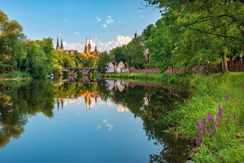 Merseburg Cathedral and Merseburg Castle reflected in the Saale River in the morning light,