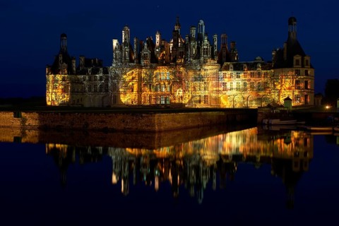 Chambord Castle with summer evening light show and moat, Chambord, Loir-et-Cher department, Centre