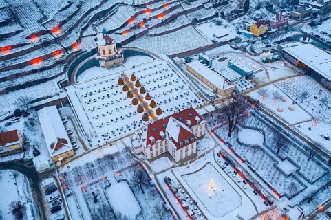 Aerial view of Wackerbarth Castle with castle park, belvedere and vineyards with snow and Christmas