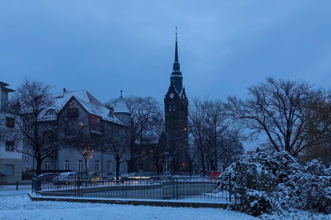 Slightly snow-covered Wettinplatz with tower of the New Church, Coswig, Saxony, Germany, Europe