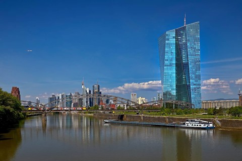 ECB European Central Bank with cargo ship on the river Main and the skyline of Frankfurt am Main,