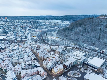 Winter city view with river, viaduct and snow-covered hills, Nagold, Black Forest, Germany, Europe