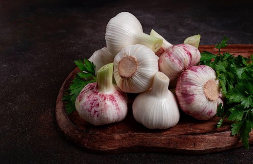 Fresh young garlic, white and purple color, on a wooden table, no people