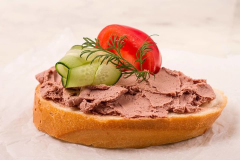Liver meat pate spread, on white bread, on a light background, breakfast, close-up, no people,