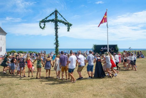 Traditional midsummer celebration with dancing around the maypole at Smygehuk, Smygehamn,