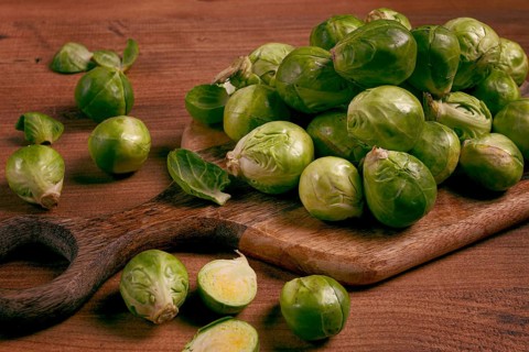 Fresh Brussels sprouts, raw, top view, on a wooden table, no people