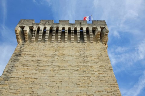 Porte d'Orange with battlements, city gate with French national flag, defence defence tower, view