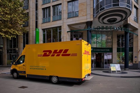 DHL delivery vehicle, logo, delivery, parked in front of Globetrotter department stores' chain,